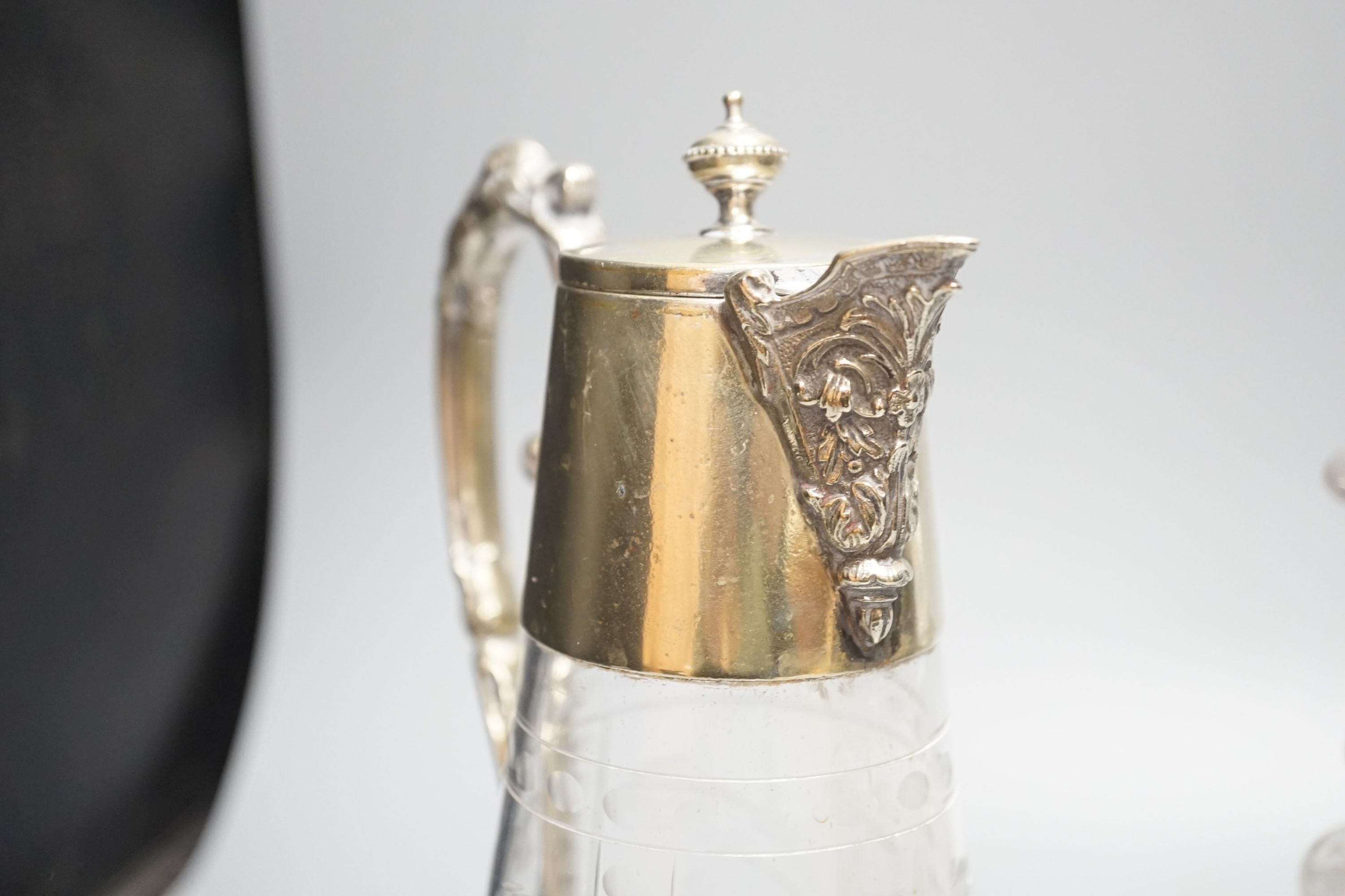 Two cut glass decanters and a claret jug 30cm